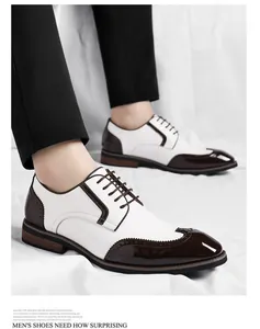 Close-up of elegant men's white and brown Brogue business shoes with polished toe