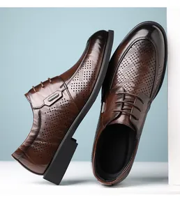 Detailed view of men's brown brogue leather shoes with hollowed-out vintage texture.
