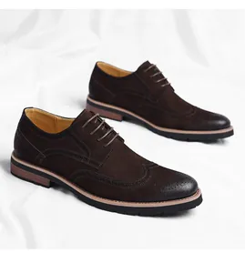 Close-up detail of classic dark brown men's wingtip Oxford shoes with brogue patterns.