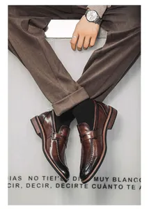 Macro detail showing men's brown leather slip-on loafers with a stylish pointed toe design.