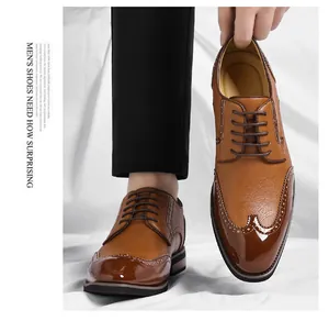 Close-up of men's brown Brogue leather dress shoes with glossy toe and wingtip details