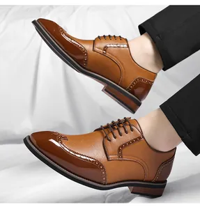 Detailed view of men's brown brogue dress shoes showing polished wingtip and texture