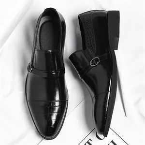Classic black men's dress shoes featuring crocodile texture and monk strap detail.