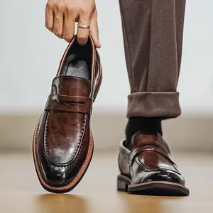 Classic men's British style brown leather loafers with a comfortable slip-on casual design