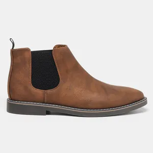 Side profile of brown vintage Chelsea boots featuring elastic side panels and durable soles.