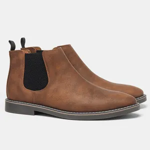 Detail view of men's brown faux leather Chelsea boots featuring black elastic side panels