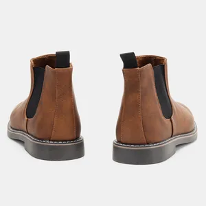 Rear view detail of brown men's Chelsea boots showing elastic panels and pull tabs