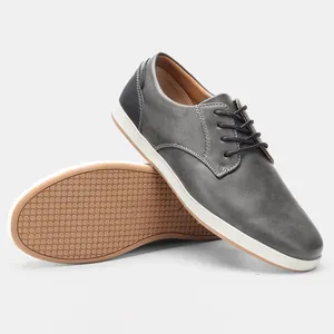 Dettaglio scarpe casual da uomo in pelle grigia con suola antiscivolo a nido d'ape