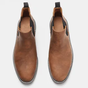 Top view detail of brown faux leather men's Chelsea boots with classic round toe