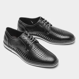 Detailed side view of men's breathable black hollow leather casual oxford dress shoes