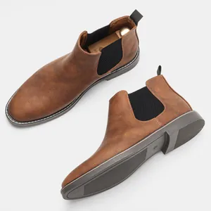 Side and sole view of brown vintage Chelsea boots for men with high-quality texture