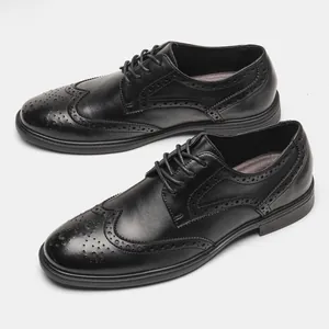Detailed shot of black genuine leather Brogue Derby shoes with intricate carved patterns.