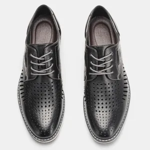 Overhead view of black breathable hollowed-out men's casual leather shoes