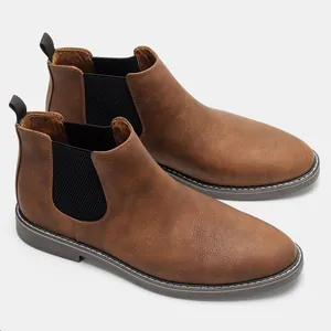 Side view of classic brown men's Chelsea boots with elastic side panels and stitching.