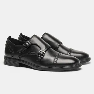 Close-up side view of premium black leather monk strap dress shoes with brogue detailing