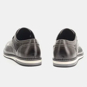 Close-up rear view of brown hollowed leather shoes for men showing sole and stitch detail