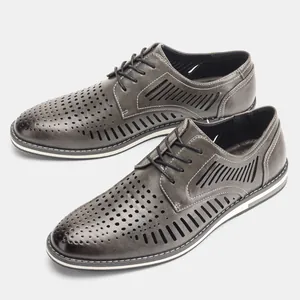 Close-up of men's breathable grey hollow-out leather shoes with stylish perforations.