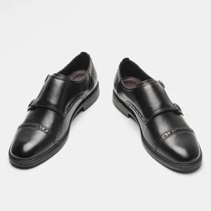 Classic black leather monk strap shoes with intricate brogue detailing for men.
