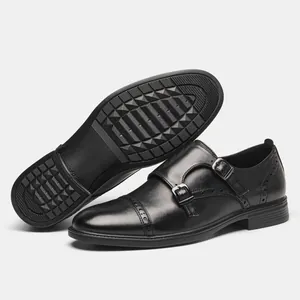 Detailed view of men's black leather double monk strap shoes with brogue accents