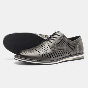 Close-up of men's dark grey perforated leather-like dress shoes with lace-up design