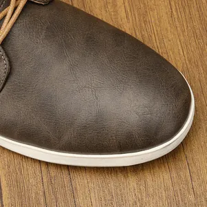 Primer plano detallado de la textura de cuero sintético marrón en un zapato de hombre