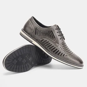 Detail view of men's grey hollowed breathable leather shoes with textured sole.