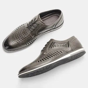 Macro view of breathable hollow-out patterns on grey casual men leather derby shoes