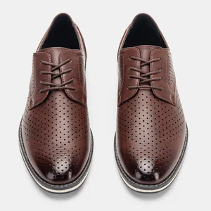 Overhead detail of men's brown breathable perforated dress shoes with lace-up design