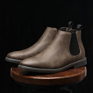 Stivali Chelsea classici in pelle marrone da uomo con pannelli elastici su sgabello
