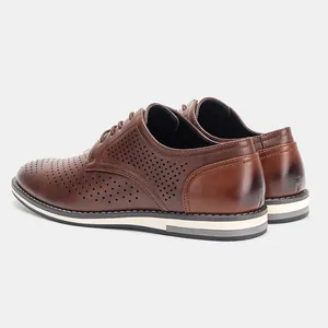 Detailed rear view of brown perforated leather oxfords with breathable holes and layered sole