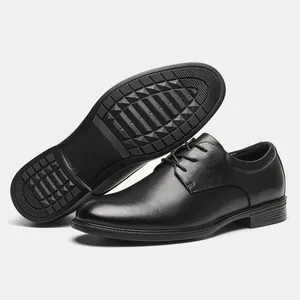 Close-up of black leather Derby shoes showing polished upper and non-slip rubber sole