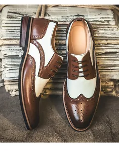 Detailed view of two-tone brown and white leather wingtip brogue shoes for men