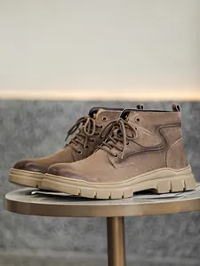 Detailed side view of rugged brown high-top outdoor work boots for men for winter