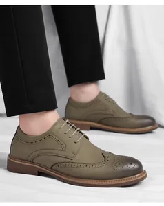 Detailed view of olive green men's Brogue dress shoes with classic lace-up design and carvings