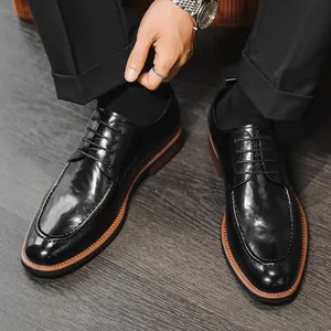 Classic black leather business dress shoes for men with elegant brown sole detail