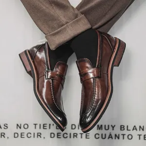 Classic brown burnished leather penny loafers with a pointed toe for business formal wear