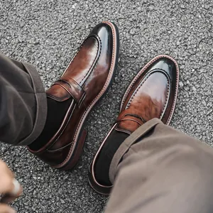 Elegant men's burnished brown leather loafers in a classic pointed business dress style
