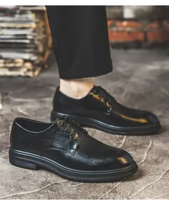Detailed view of black crocodile-pattern men's formal business derby shoes on model.