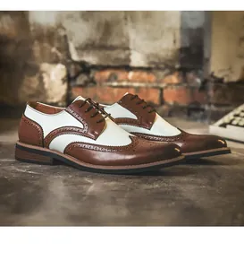 Two-tone brown and white wingtip brogue shoes for men in a vintage setting