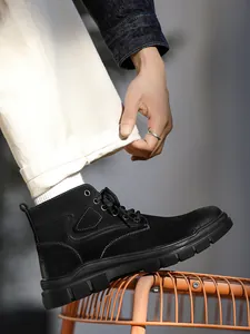 Close-up view of premium black high-top outdoor work boots with durable rubber soles