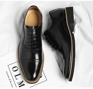 Close-up of black leather cap-toe Oxford shoes with brogue detailing