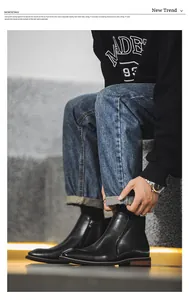 Detailed view of men's black leather Chelsea boots featuring a side zipper design