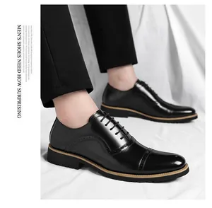 Close-up of elegant black leather cap-toe dress shoes with brogue details for men