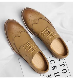 Detailed view of tan Brogue oxfords with classic wingtip perforated patterns for men