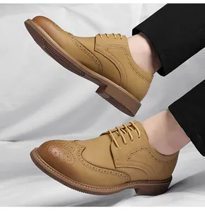 Detail view of men's tan leather Brogue shoes with classic wingtip wing engravings