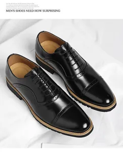 Elegant black leather Oxford shoes for men with classic brogue detailing on white background