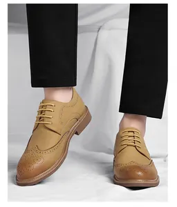Close-up of tan men's Brogue dress shoes with decorative perforations and lace-up.