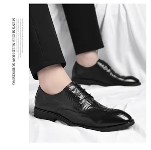 Close-up of black crocodile-patterned business leather shoes with elegant brogue detailing