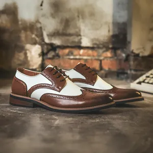 Classic men's two-tone wingtip brogue dress shoes in stylish brown and white leather