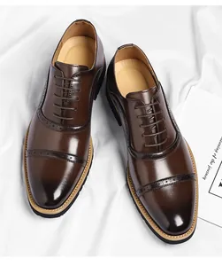 High-angle view of premium brown men's cap-toe business shoes with brogue details